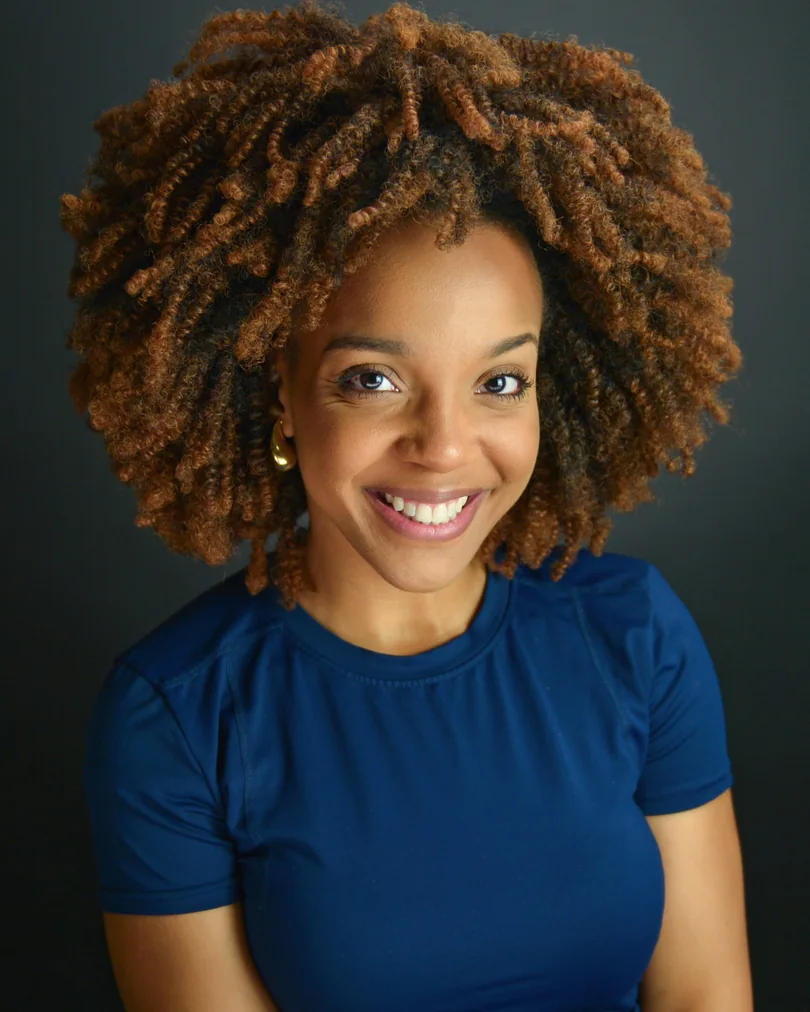 Studio actor headshot with natural curls and a blue top