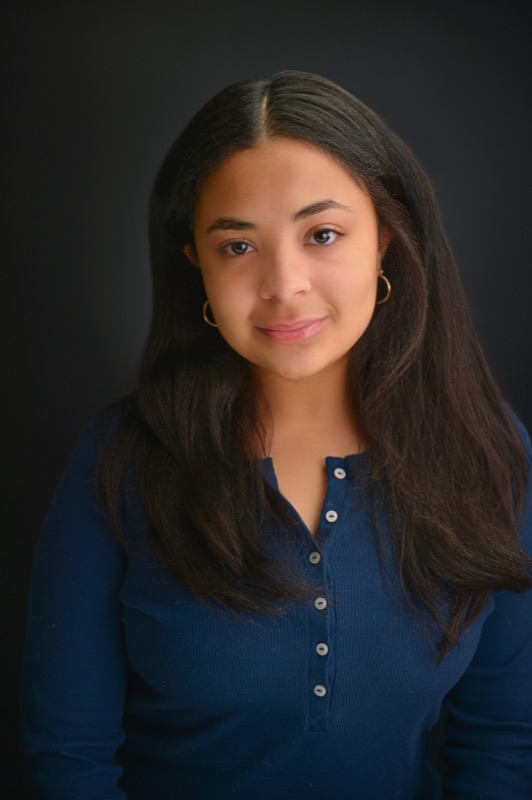 A modern theatrical headshot with a focused expression