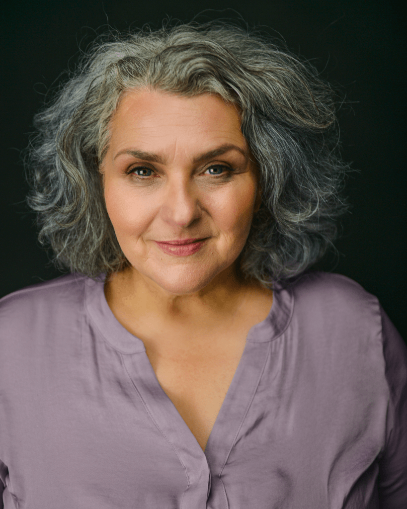 Clean actor headshot with a relaxed and confident expression.